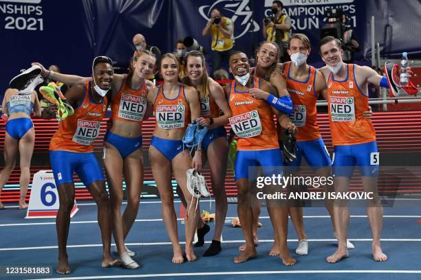 Netherlands' athletes celebrate winning both the men's and the women's 4x400m relays at the 2021 European athletics Indoor Championships in Torun on...