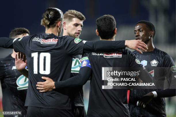 Lille's French forward Isaac Lihadji is congratulated by teammates after scoring a goal during the French Cup round-of-32 football match between GFC...