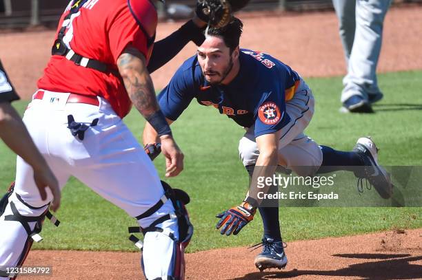 Garrett Stubbs of the Houston Astros slides into home plate during the fifth inning of Spring Training game against the St. Louis Cardinals at Roger...