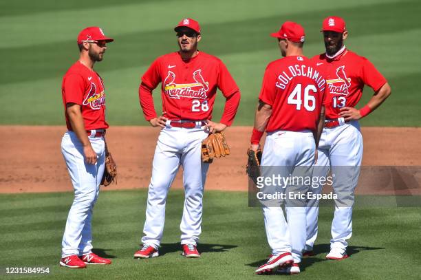 Paul DeJong of the St. Louis Cardinals talks with Nolan Arenado, Paul Goldschmidt and Matt Carpenter during a pitching change in the fifth inning of...