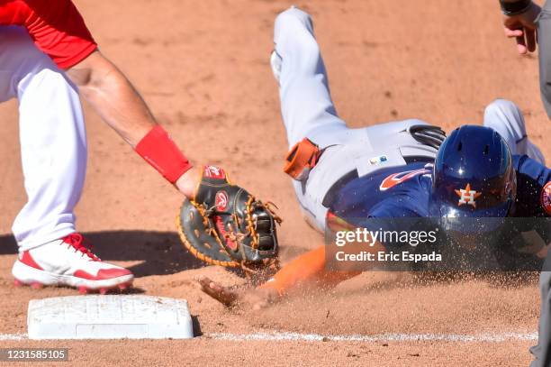 Jose Siri of the Houston Astros dives back to first base during the Spring Training game against the St. Louis Cardinals at Roger Dean Chevrolet...