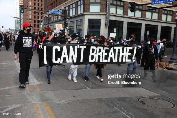 Demonstrators carry a banner during an 'I Can't Breathe' Silent March For Justice in Minneapolis, Minnesota, U.S., on Sunday, March 7, 2021. Derek...