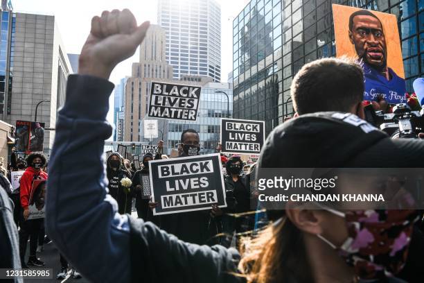Demonstrators hold placards during the "I Can't Breathe - Silent March for Justice" in front of the Hennepin County Government Center on March 7...