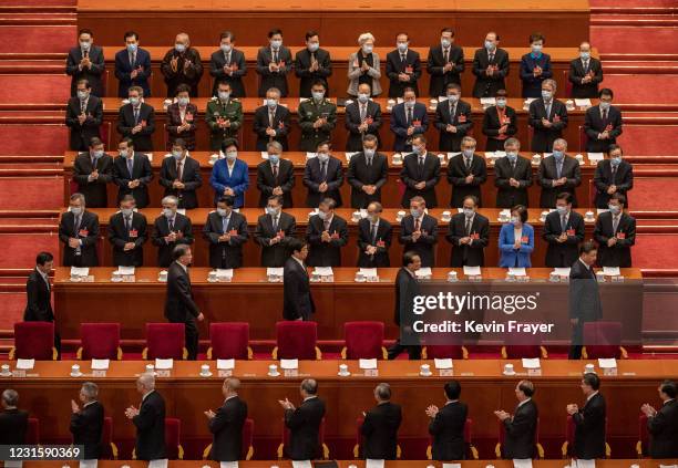 Chinese President Xi Jinping, bottom right, and Premier Li Keqiang, second right, Li Zhansu, third right, are applauded by members of the government...