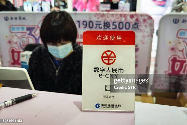 Sign for Chinas new digital currency, electronic Chinese yuan is displayed at a shopping mall in Shanghai on March 8, 2021. - China OUT / China OUT