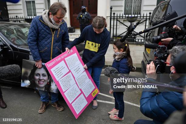 Richard Ratcliffe , husband of British-Iranian aid worker Nazanin Zaghari-Ratcliffe jailed in Tehran since 2016, holds a board as he and his daughter...