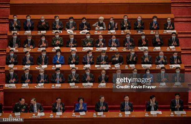 Lawmakers applaud at the second plenary session of the National People's Congress at the Great Hall of the People on March 8, 2021 in Beijing, China....