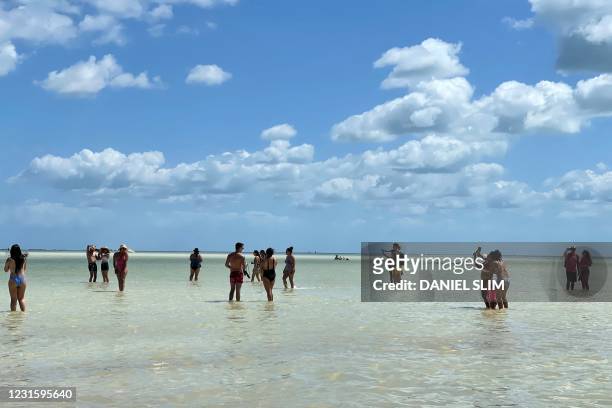 Tourists enjoy Holbox Island, Mexico, on March 7, 2021. - Holbox is famous for its large congregation of whale sharks and as ideal destination for...