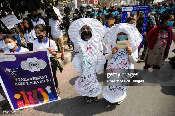 Women dressed in sanitary pads shape costumes seen participating as they demand tax-free pads during the international women's Day. Demonstrators...