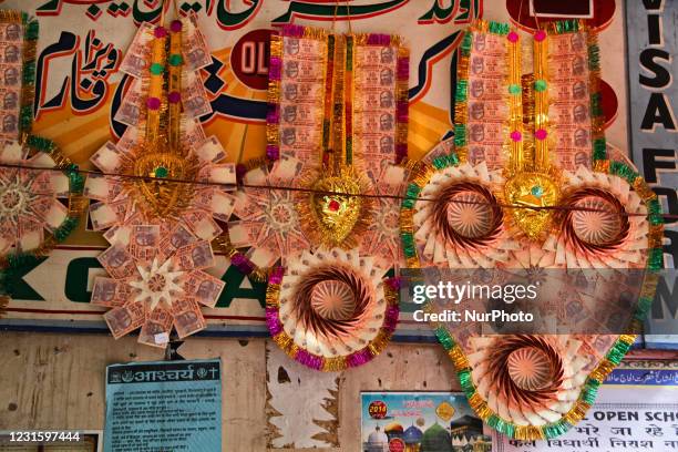 Muslim wedding garlands made with Indian rupee currency notes for sale in the market near the Jamia Masjid in Old Delhi, India.