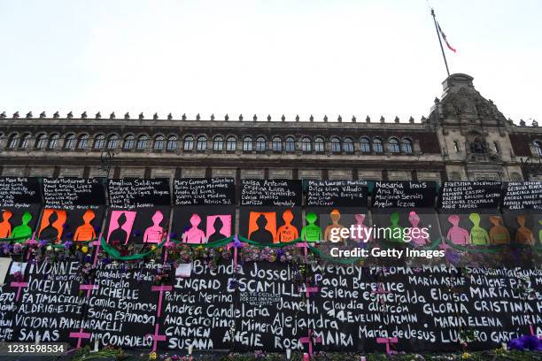 Names of feminicide victims slogans and flowers intervene fences placed outside the National Palace ahead of demostrations as part of the...