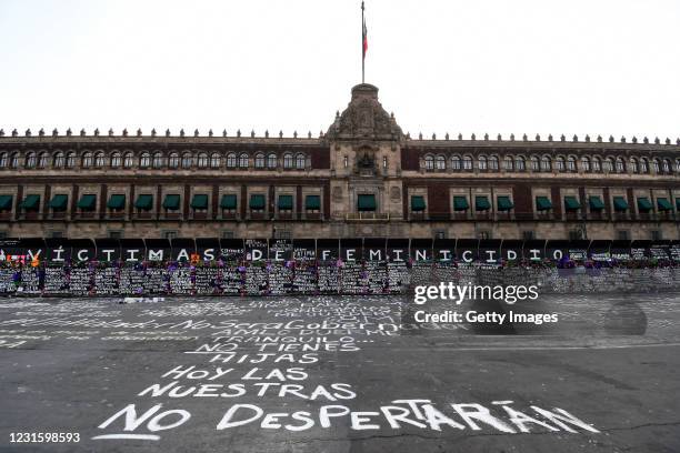 Names of feminicide victims, slogans and flowers intervene fences placed outside the National Palace ahead of demostrations as part of the...