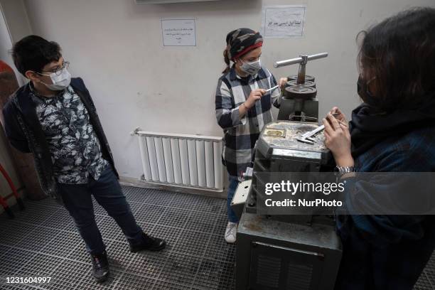 Iranian 30-year-old female and owner of the Shamim Jewelry brand, Shamim Yousefi , works in a jewelry workshop in northwestern Tehran on February 27,...