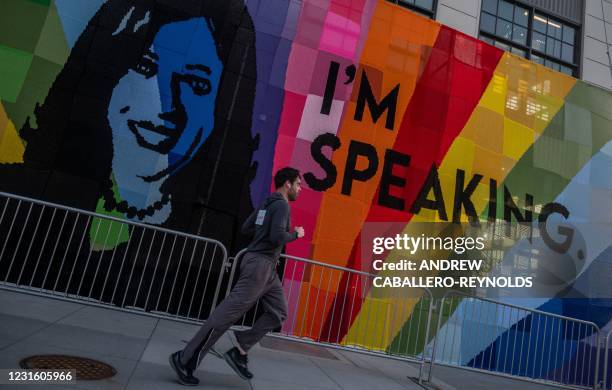 Man runs past a large-scale, outdoor crochet art installation of US Vice President Kamala Harris in celebration of International Women's Day, by...