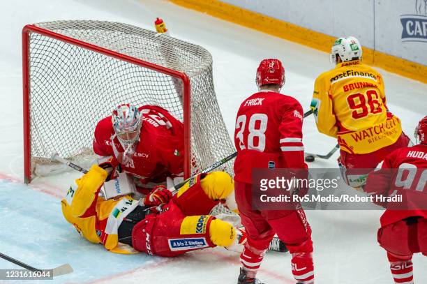 Mike Kunzle of EHC Biel clashes with Goalie Luca Boltshauser of Lausanne HC during the Swiss National League game between Lausanne HC and EHC...