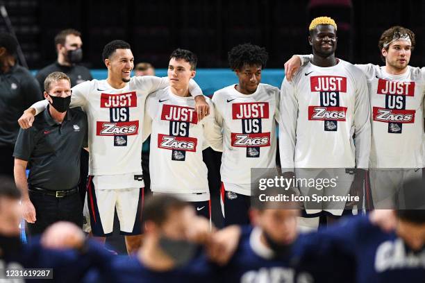 Gonzaga head coach Mark Few and Gonzaga guard Jalen Suggs look on during the national anthem before the semifinal game of the men's West Coast...