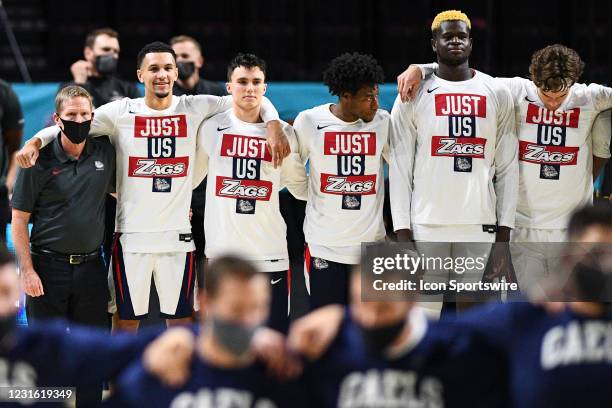 Gonzaga head coach Mark Few and Gonzaga guard Jalen Suggs look on during the national anthem before the semifinal game of the men's West Coast...