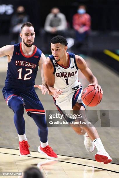 Gonzaga guard Jalen Suggs drives past St. Mary's guard Tommy Kuhse during the semifinal game of the men's West Coast Conference basketball tournament...