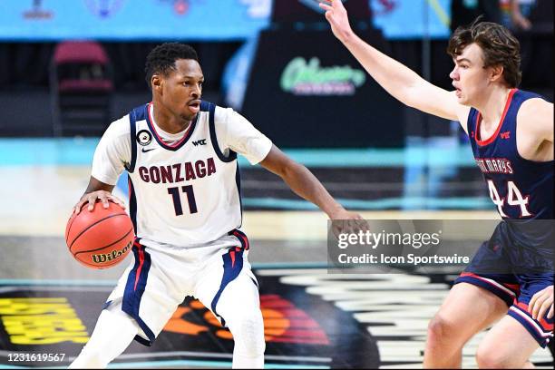 Gonzaga forward Joel Ayayi looks to drive past St. Mary's forward Alex Ducas during the semifinal game of the men's West Coast Conference basketball...