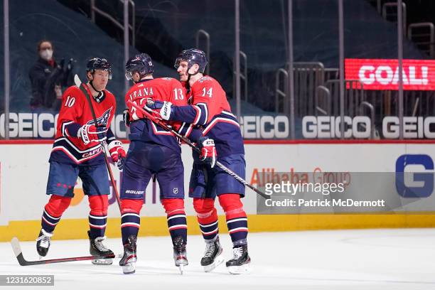 Jakub Vrana of the Washington Capitals celebrates with teammates Daniel Sprong and Richard Panik after scoring the game winning goal against the New...