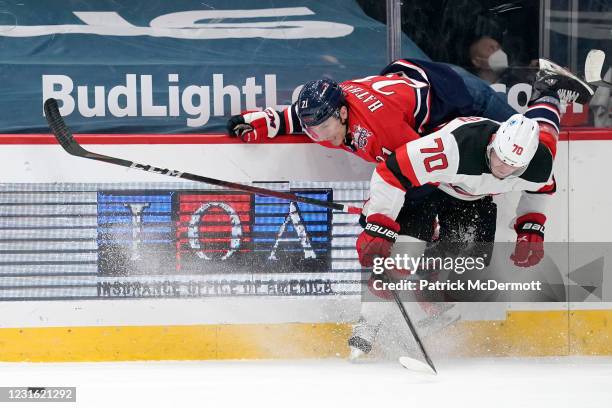 Garnet Hathaway of the Washington Capitals is upended by Dmitry Kulikov of the New Jersey Devils in the third period at Capital One Arena on March...