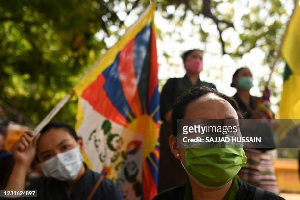 Tibetans living in exile take part in a protest to commemorate the anniversary of the 1959 Tibetan uprising against Chinese rule, in New Delhi on...