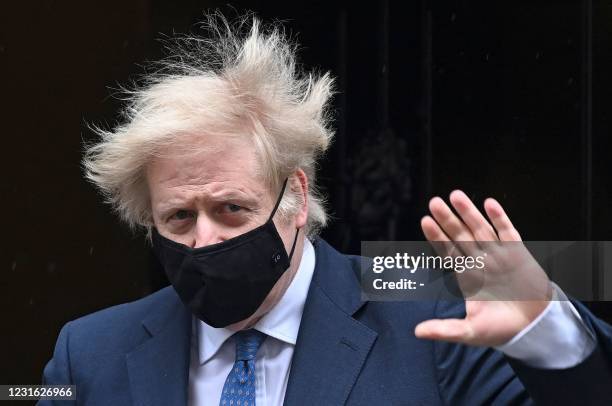 Britain's Prime Minister Boris Johnson, wearing a protective face covering to combat the spread of the coronavirus, leaves 10 Downing Street in...