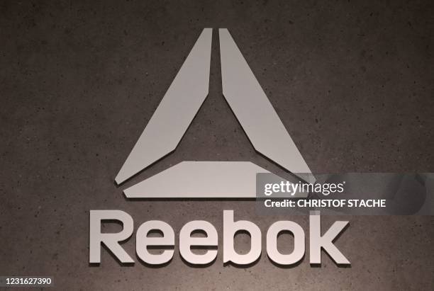 The logo of footwear and clothing company Reebok, a subsidiary of German sporting goods giant Adidas, is seen in a store on March 10, 2021 in Munich,...