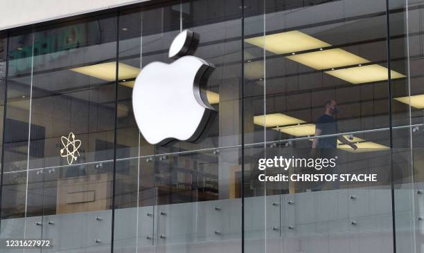 The logo of US tech giant Apple can be seen on an Apple store in Munich, southern Germany. - Apple said it planned to invest more than one billion...