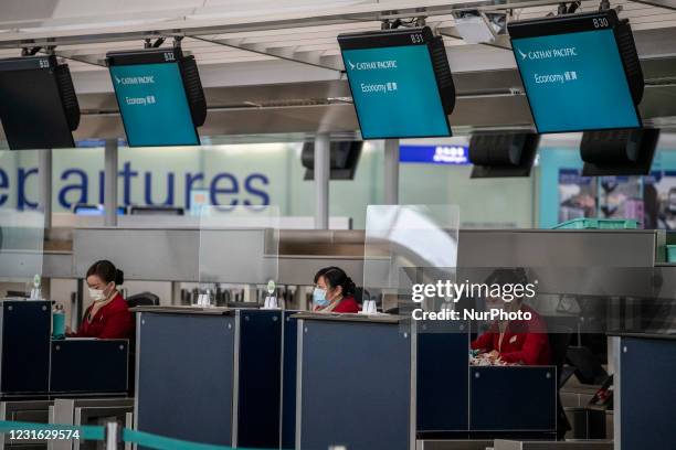 Staff at a Cathay Pacific Check in Counter in Hong Kong International Airport in Hong Kong, Wednesday, March 10, 2021. Cathay Pacific Announced a...