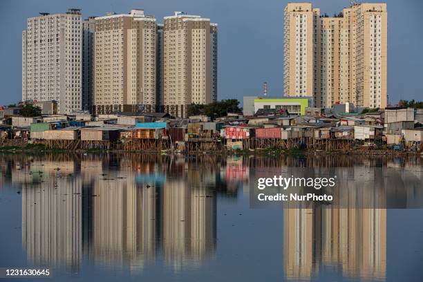 This picture shows a slum area on the Pluit dam in Jakarta on March 10, 2021. The Governor of Bank Indonesia Perry Warjiyo projected that the economy...