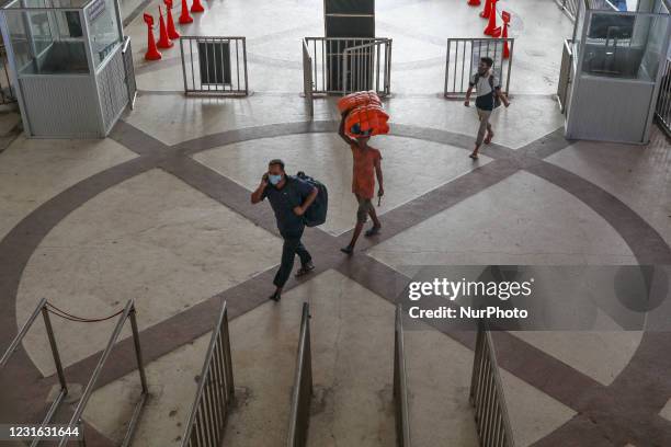 People leave for village by train at Kamalapur railway station in Dhaka on March 10, 2021.