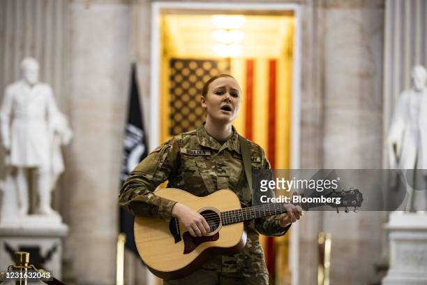 Member of the National Guard performs a song for a National Guard Public Affairs officer in the Rotunda of the U.S. Capitol in Washington, D.C.,...