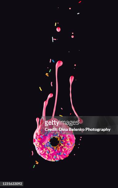 donut with a splash of pink glazing, high-speed food photography - sprinkling ストックフォトと画像