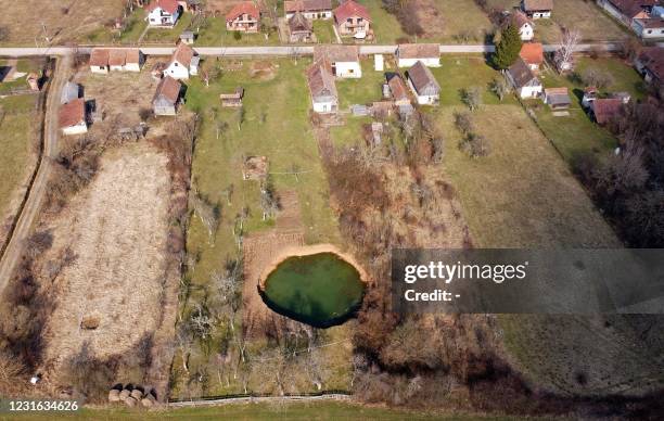 An aerial picture taken on March 10, 2021 shows a sinkhole in the village of Mecencani. The region about 40 kilometers southwest of the capital,...