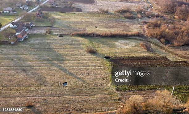 An aerial picture taken on March 10, 2021 shows sinkholes in the village of Mecencani. - The region about 40 kilometers southwest of the capital,...