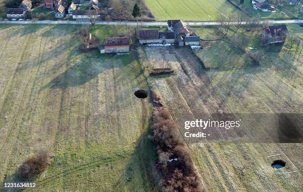 An aerial picture taken on March 10, 2021 shows sinkholes in the village of Mecencani. - The region about 40 kilometers southwest of the capital,...