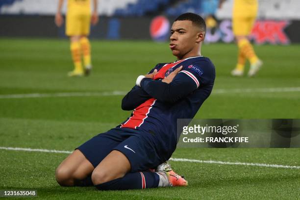 Paris Saint-Germain's French forward Kylian Mbappe celebrates after scoring a penalty kick during the UEFA Champions League round of 16 second leg...
