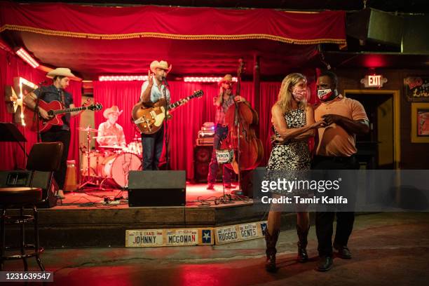 Lloyd Weatherspoon and Hope Wilson dance during a break between songs performed by Johnny McGowan's Rugged Gents at The White Horse on March 10, 2021...