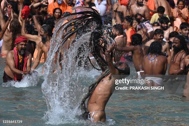 Naga Sadhus take holy dip in the waters of the River Ganges on the Shahi snan on the occasion of Maha Shivratri festival during the ongoing religious...