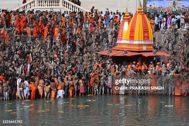 Naga Sadhus gather before taking holy dip in the waters of the River Ganges on the Shahi snan on the occasion of Maha Shivratri festival during the...