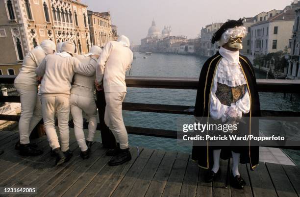 View down the Grand Canal with Venetians wearing period costumes and masks during the Carnival in Venice which takes place during the week leading up...