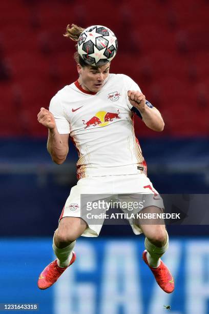 Leipzig's Austrian forward Marcel Sabitzer heads the ball during the UEFA Champions league Last 16 2nd Leg football match between Liverpool and RB...