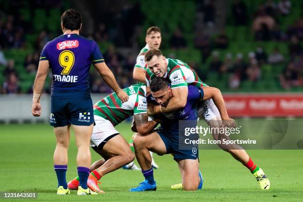 Jesse Bromwich of the Storm is tackled during the round 1 NRL match between the Melbourne Storm and South Sydney Rabbitohs at AAMI Park on March 11,...