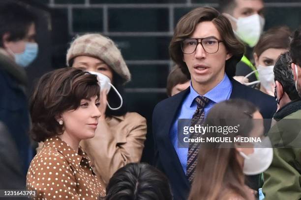 Singer, songwriter and actress Lady Gaga and US actor Adam Driver are pictured on March 11, 2021 on Piazza Duomo in central Milan on the set of the...