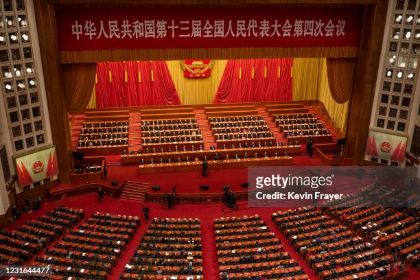 China's senior leadership and lawmakers gather during the closing session of the National People's Congress at the Great Hall of the People on March...