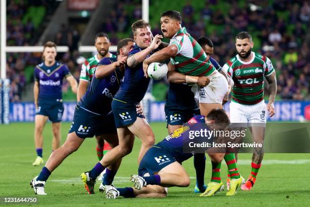 Latrell Mitchell of the Rabbitohs is tackled during the round 1 NRL match between the Melbourne Storm and South Sydney Rabbitohs at AAMI Park on...