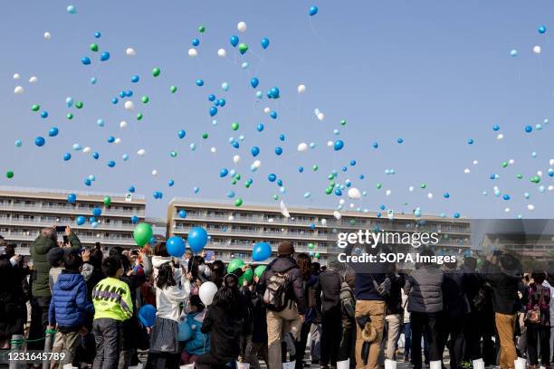 Balloons are released to the sky for prayers and as a symbol of hope during the memorial of the 2011 earth quake. Families and friends come and...