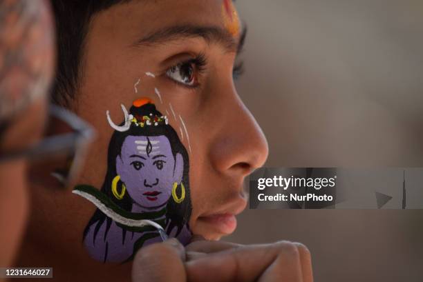 An artist making face paint of lord Shiva in face of young boy during Maha Shivaratri at Kathmandu, Nepal on Thursday, March 11, 2021. Less number of...