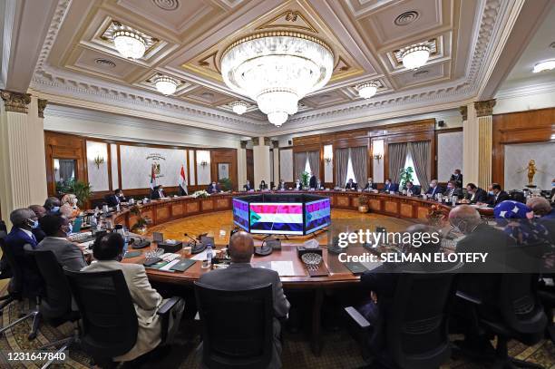 Egyptian Prime Minister Mostafa Madbouly, his Sudanese counterpart Abdalla Hamdok and other officials meet in the Egyptian capital Cairo, on March...